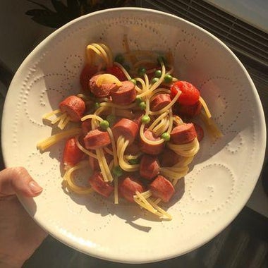 Threaded spaghetti hot dogs in a bowl.
